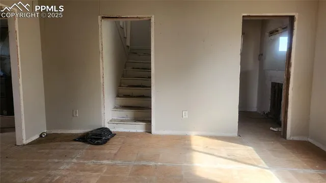 a room with a wooden floor and window