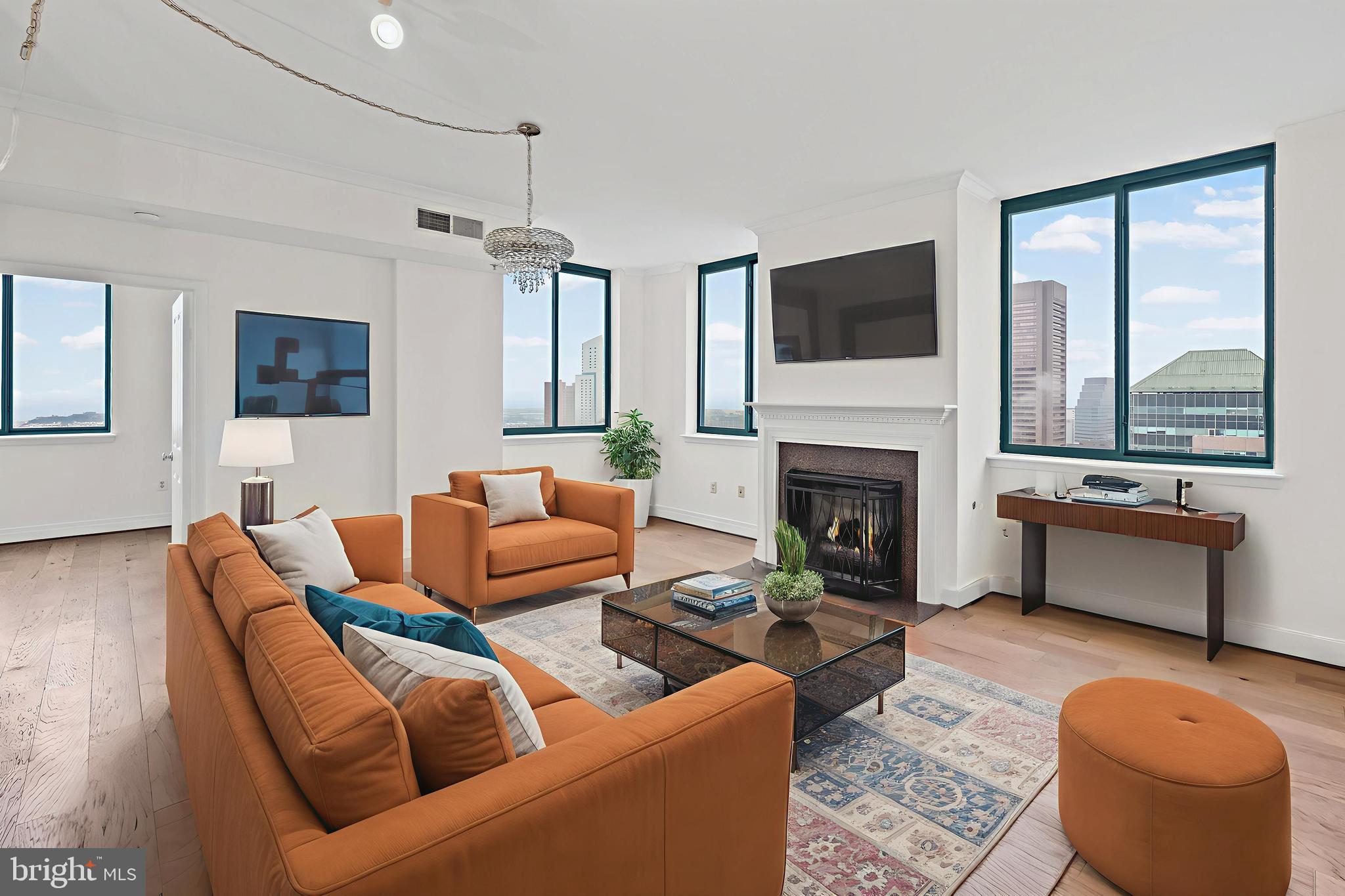 a living room with furniture a flat screen tv and a fireplace