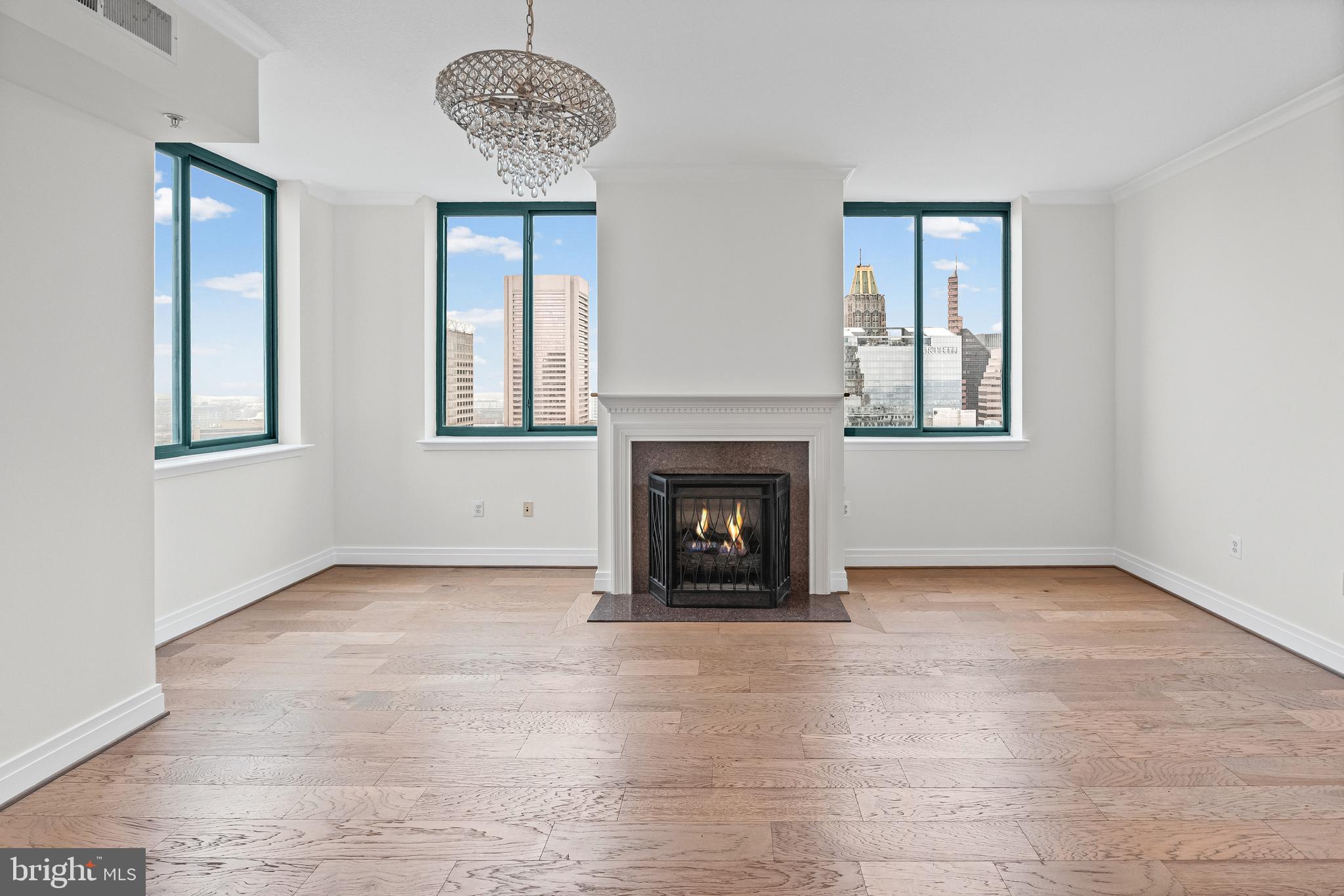 414 Water Street, Unit 2903 Baltimore, MD 21202 - Photo 11 of 46 an empty room with windows and fireplace