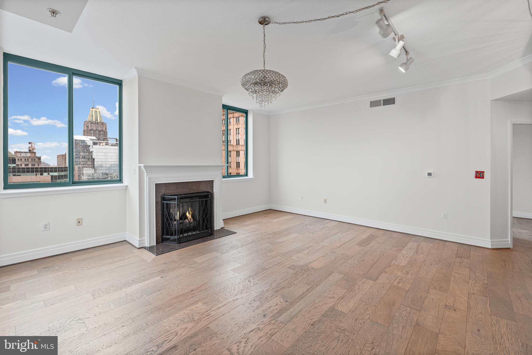 414 Water Street, Unit 2903 Baltimore, MD 21202 - Photo 12 of 46 a view of an empty room with a fireplace and window