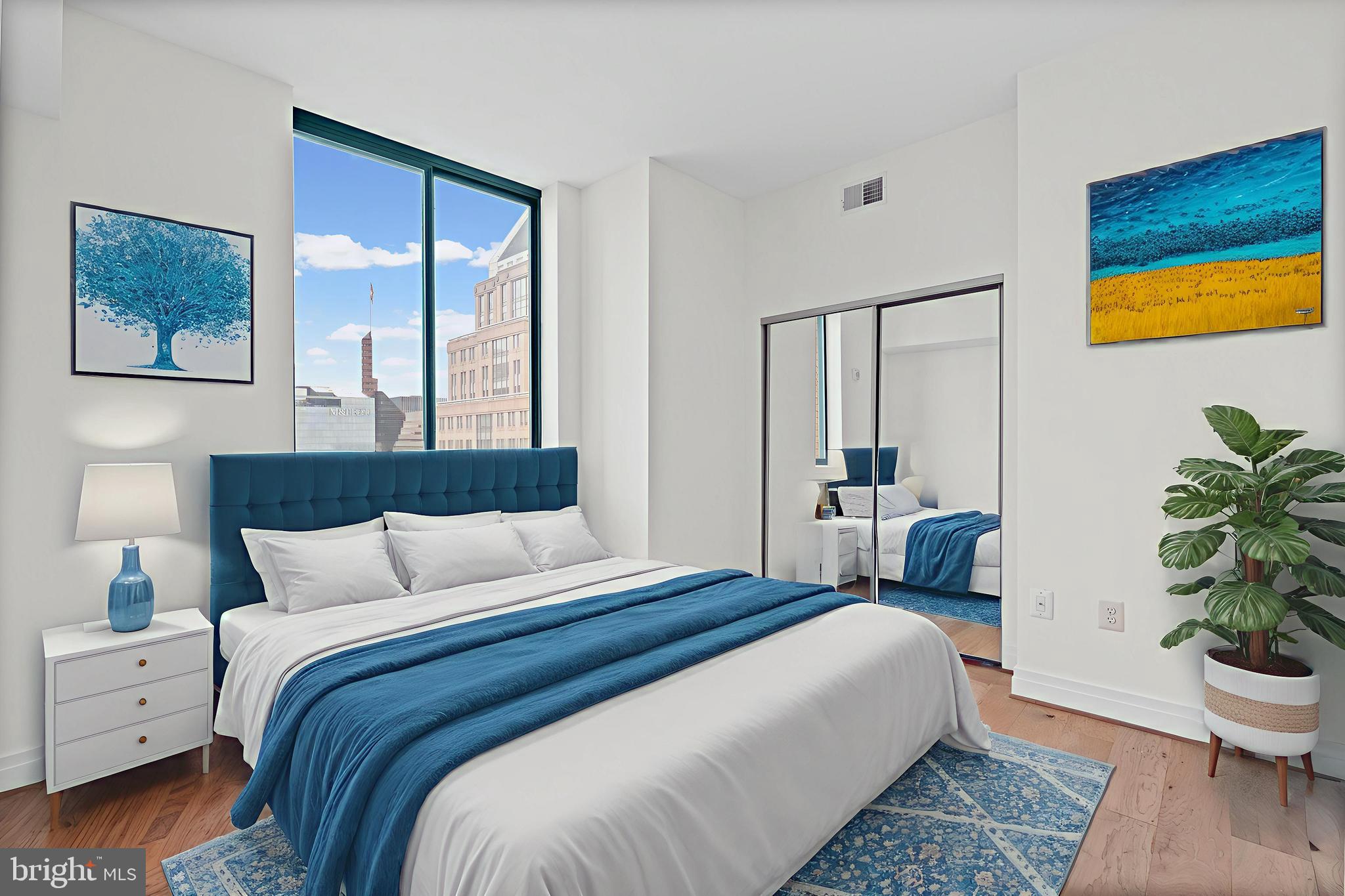 414 Water Street, Unit 2903 Baltimore, MD 21202 - Photo 15 of 46 a bedroom with a bed and a potted plant