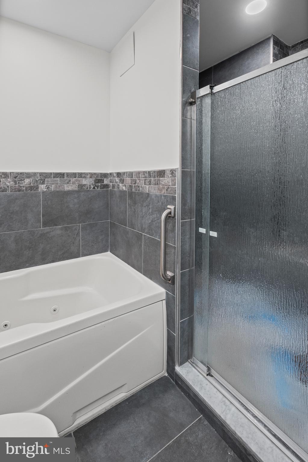 414 Water Street, Unit 2903 Baltimore, MD 21202 - Photo 25 of 46 a bathroom with a bathtub and a shower