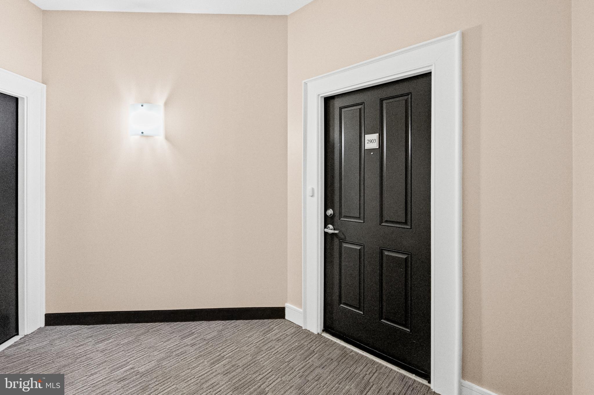 414 Water Street, Unit 2903 Baltimore, MD 21202 - Photo 3 of 46 a view of a hallway with wooden floor