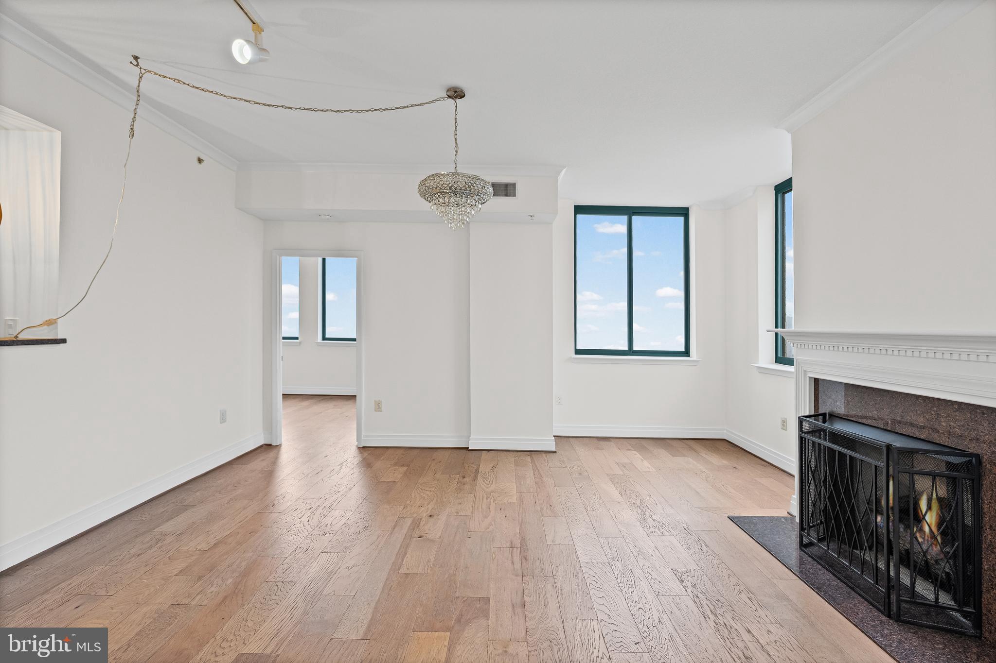 414 Water Street, Unit 2903 Baltimore, MD 21202 - Photo 10 of 46 a view of an empty room with wooden floor fireplace and a window