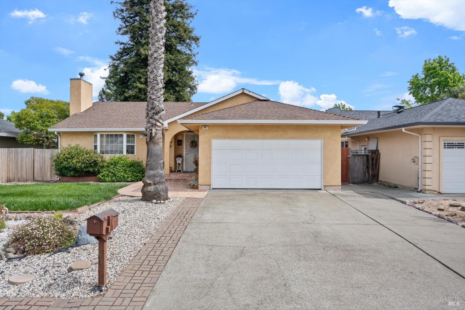 971 Eleanor Avenue Rohnert Park, CA 94928 - Photo 24 of 25 a front view of a house with a yard and garage