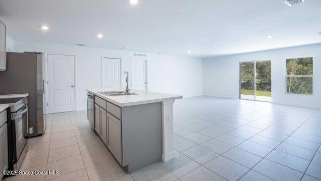 340 Wendover Road Southwest Palm Bay, FL 32908 - Photo 14 of 23 a kitchen with a sink and a refrigerator