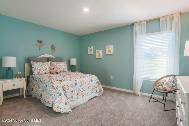 340 Wendover Road Southwest Palm Bay, FL 32908 - Photo 9 of 23 a bedroom with a bed and a window