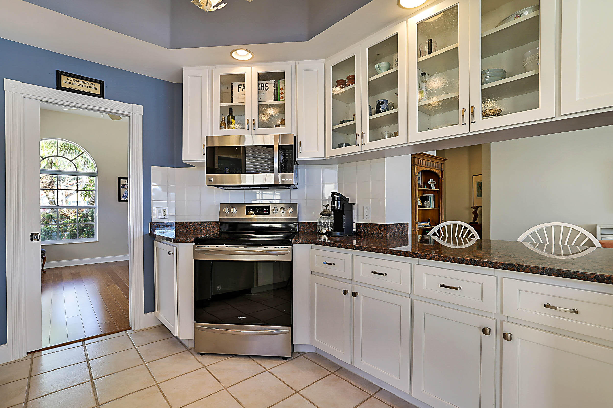 1226 Southwest Eagleglen Place Stuart, FL 34997 - Photo 13 of 45 a kitchen with stainless steel appliances granite countertop a stove and a sink