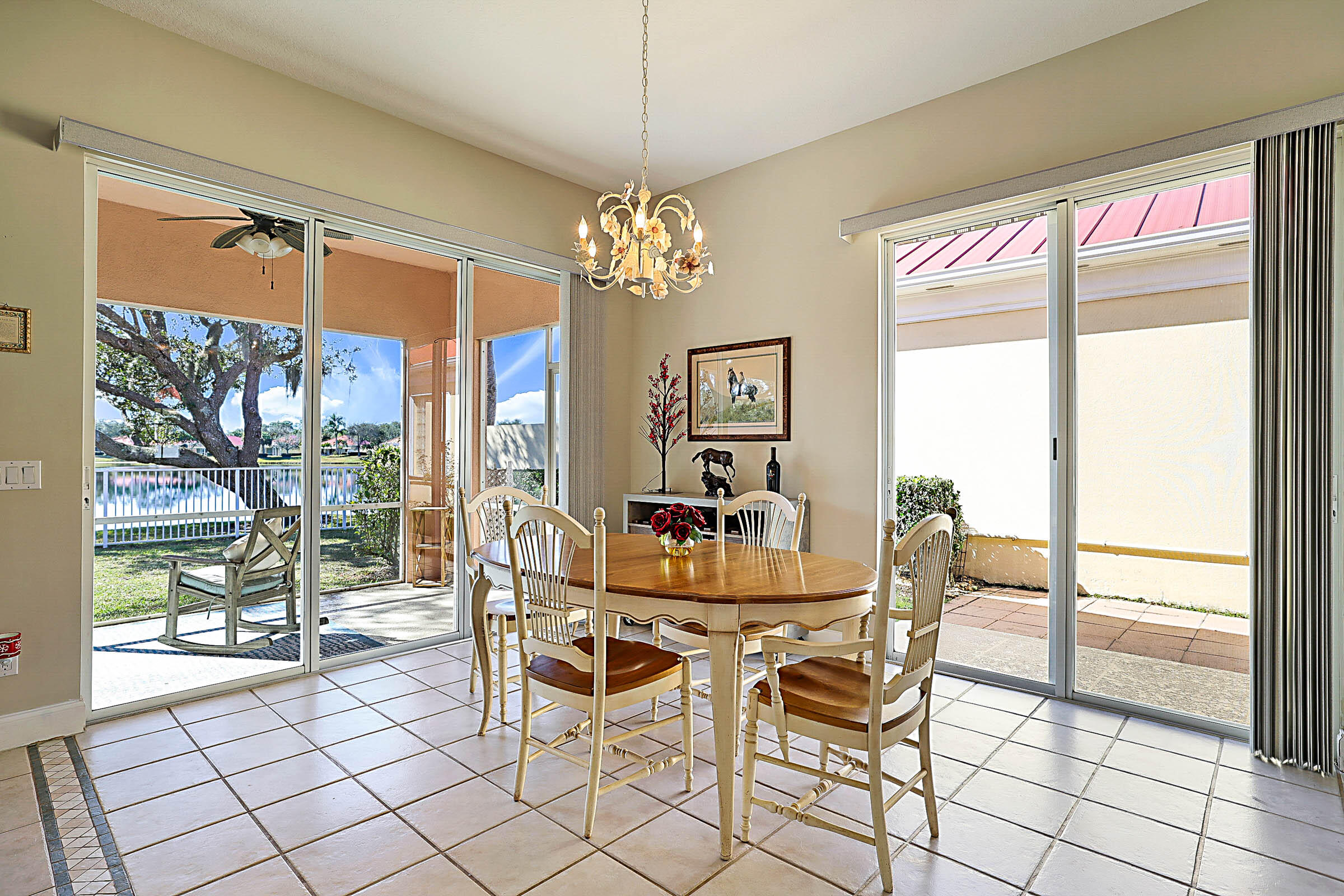 1226 Southwest Eagleglen Place Stuart, FL 34997 - Photo 16 of 45 a dining room with furniture a chandelier and wooden floor