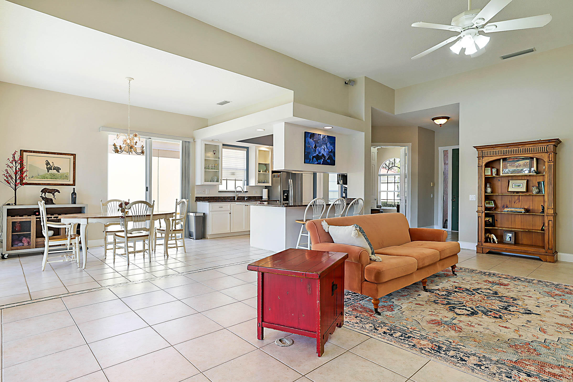 1226 Southwest Eagleglen Place Stuart, FL 34997 - Photo 6 of 45 a living room with furniture a dining table and chairs