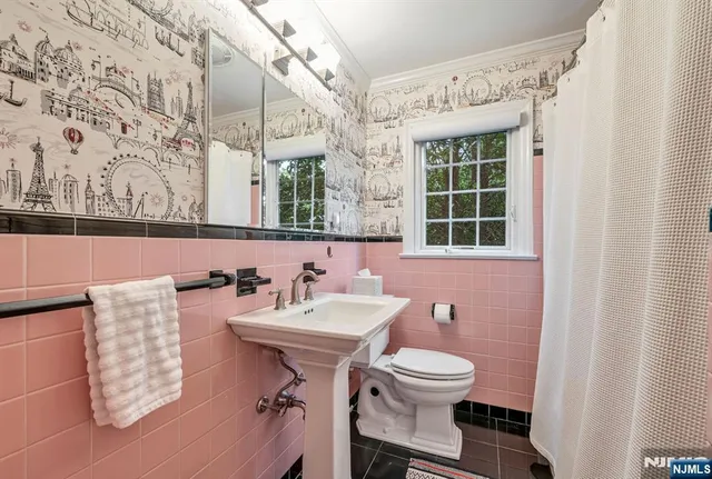 a bathroom with a toilet sink and mirror