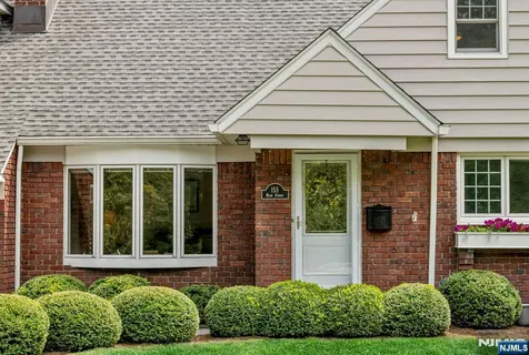 a front view of a house with a garden