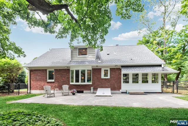 a view of a house with a backyard and a patio