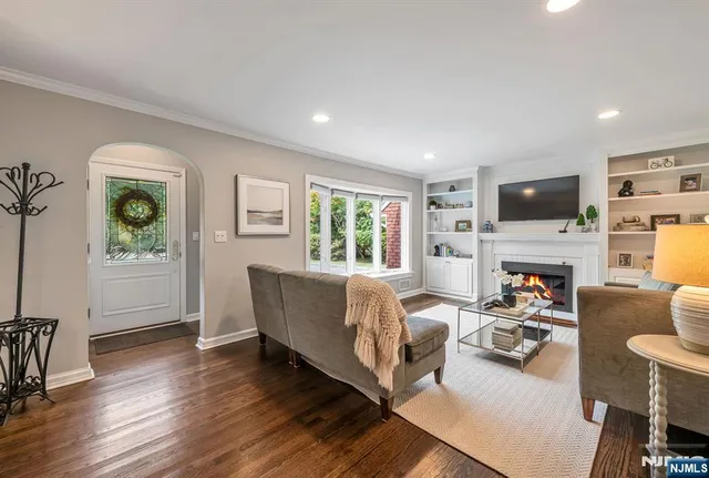 a living room with fireplace furniture and a flat screen tv