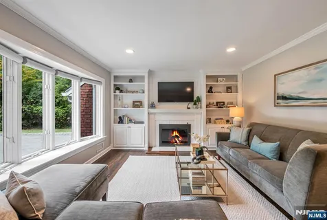 a living room with furniture fireplace and flat screen tv