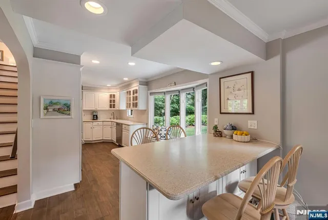 a view of a dining room with furniture and a potted plant