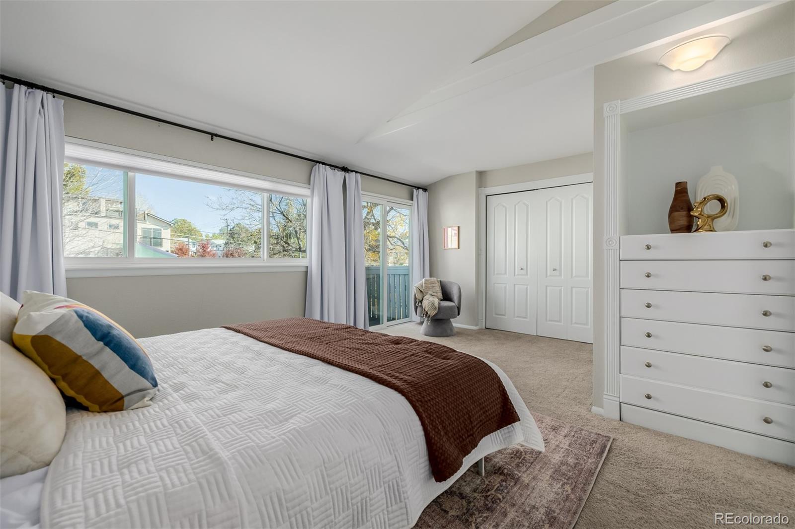 12 Jackson Street Denver, CO 80206 - Photo 15 of 48 a bedroom with a bed and a dresser