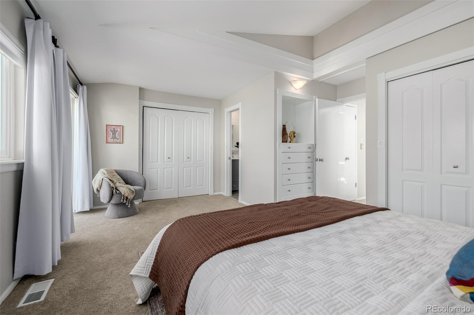 12 Jackson Street Denver, CO 80206 - Photo 16 of 48 a bedroom with a bed and a window