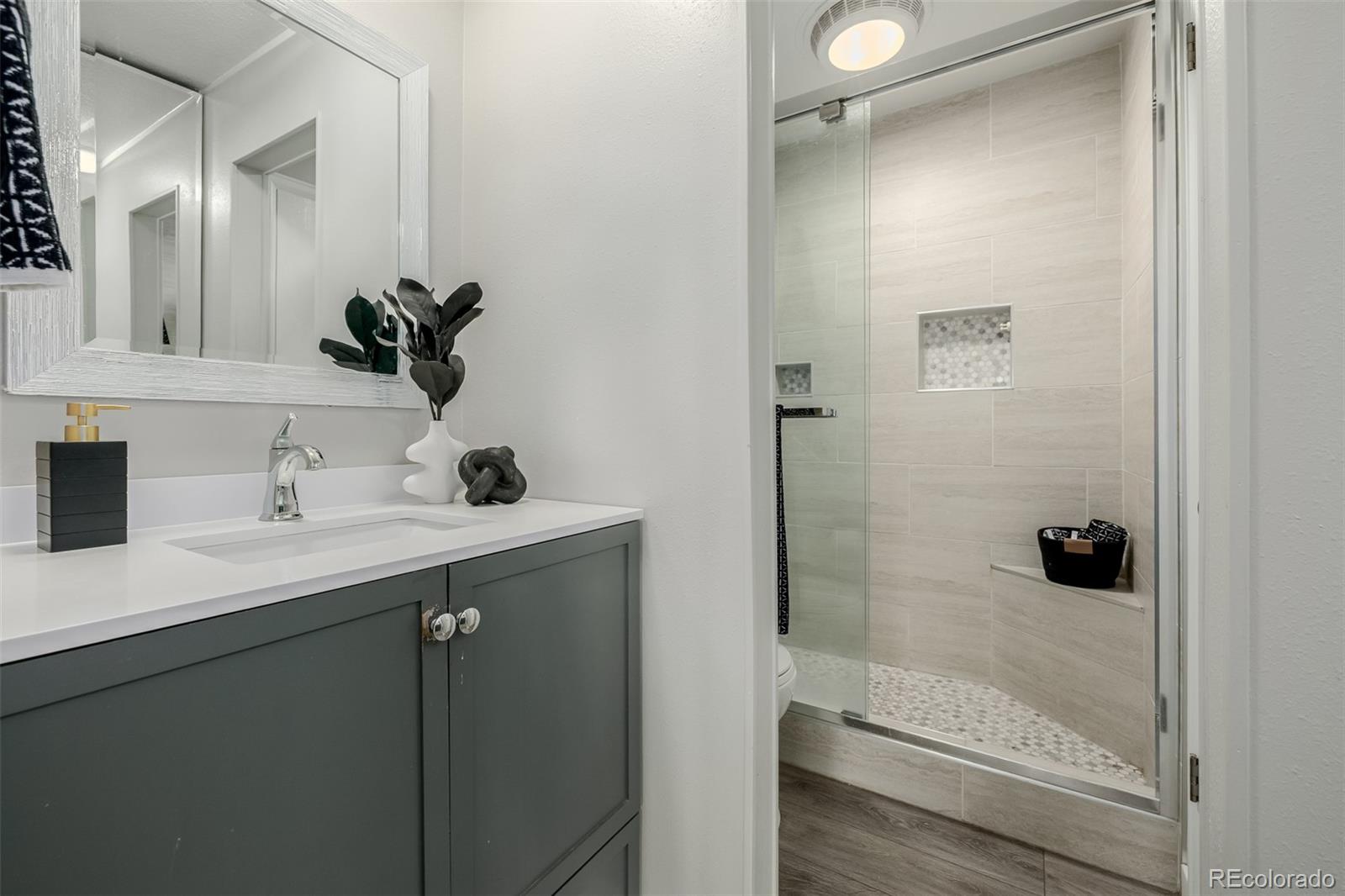 12 Jackson Street Denver, CO 80206 - Photo 17 of 48 a bathroom with a sink and a mirror