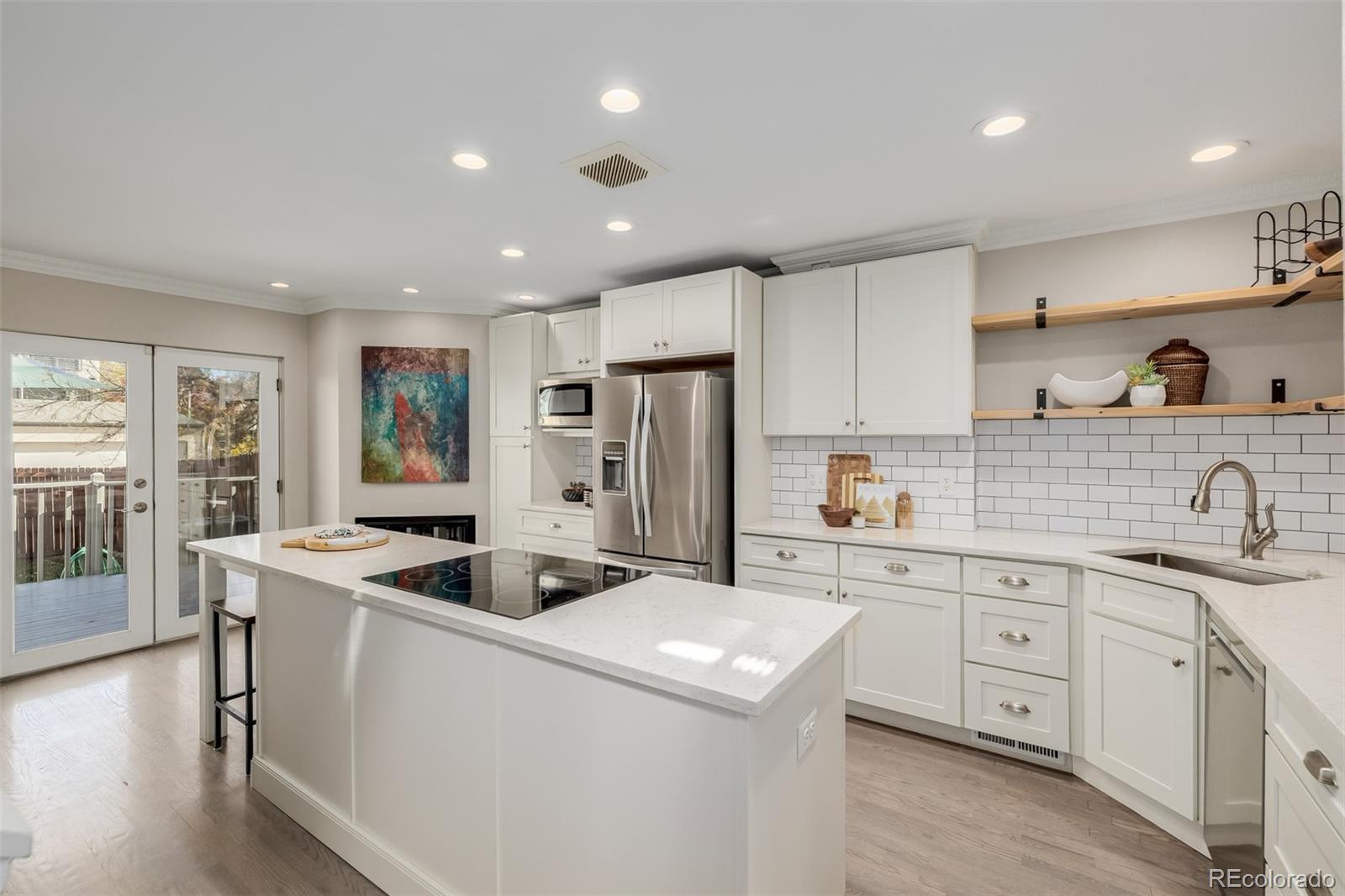 12 Jackson Street Denver, CO 80206 - Photo 2 of 48 a kitchen that has a sink a stove and a refrigerator