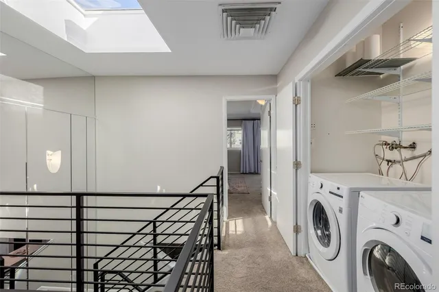 a view of a hallway with washer and dryer