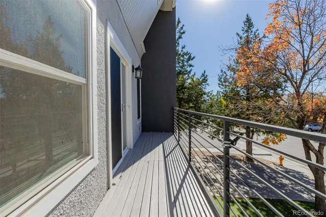 a view of balcony with wooden floor and fence