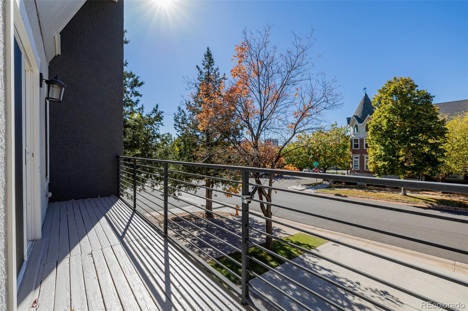 12 Jackson Street Denver, CO 80206 - Photo 28 of 48 a view of balcony with wooden floor and outdoor seating