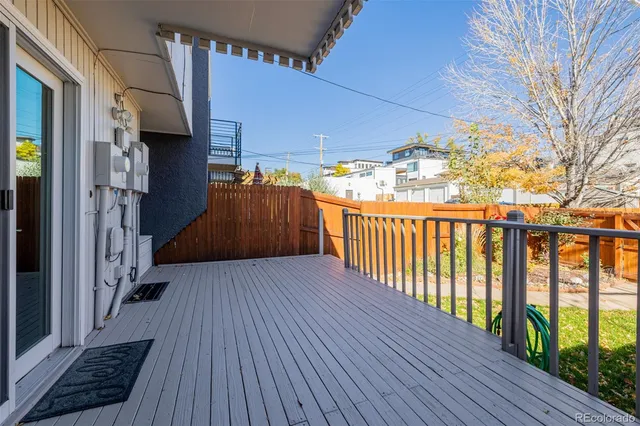 a view of a porch with wooden floor and fence