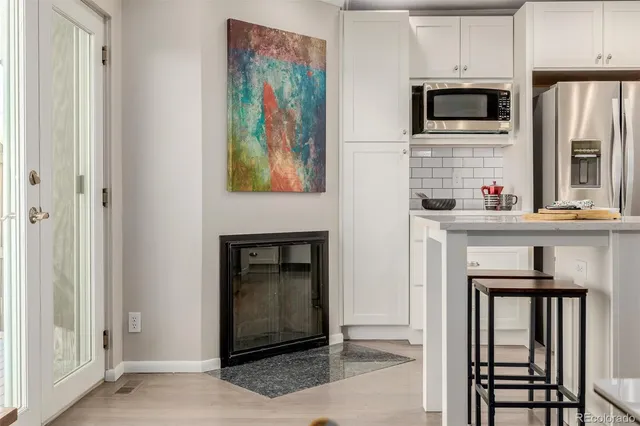 a kitchen with stainless steel appliances a stove microwave and refrigerator