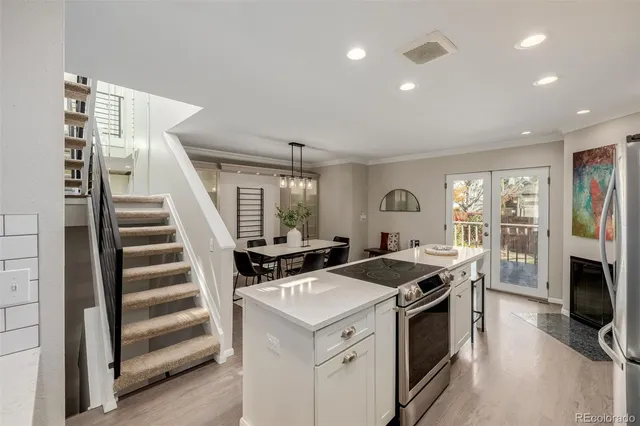 a kitchen that has a sink a stove and a refrigerator