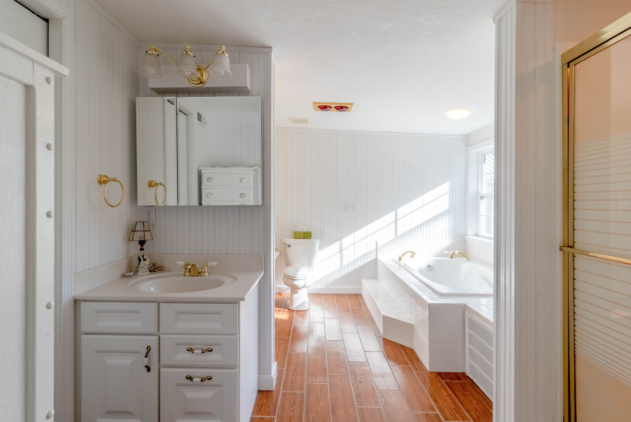 1441 Gratton Road Clarksville, TN 37043 - Photo 29 of 49 a bathroom with a sink a mirror and wooden floor