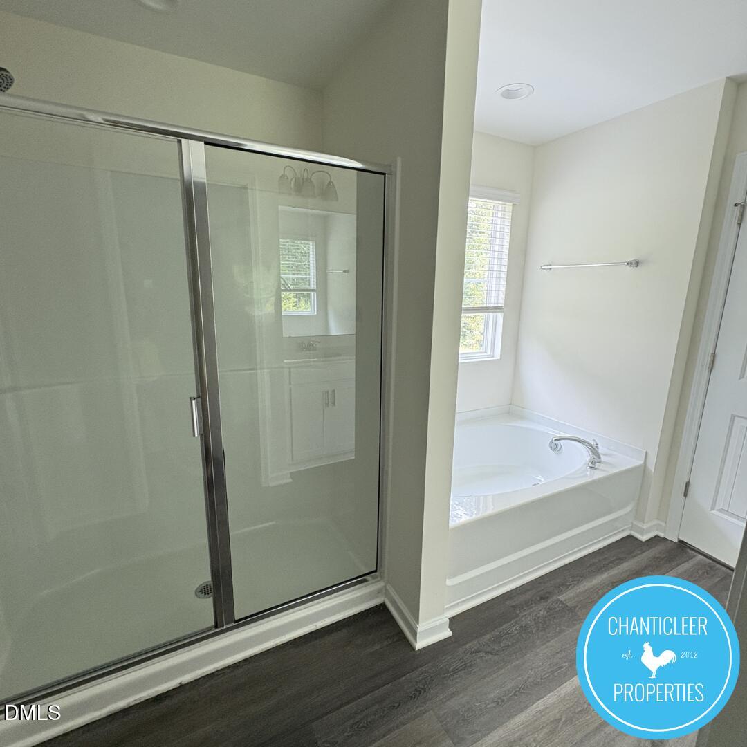 3318 Slippery Elm Drive Raleigh, NC 27610 - Photo 16 of 25 a bathroom with a glass shower door and a mirror