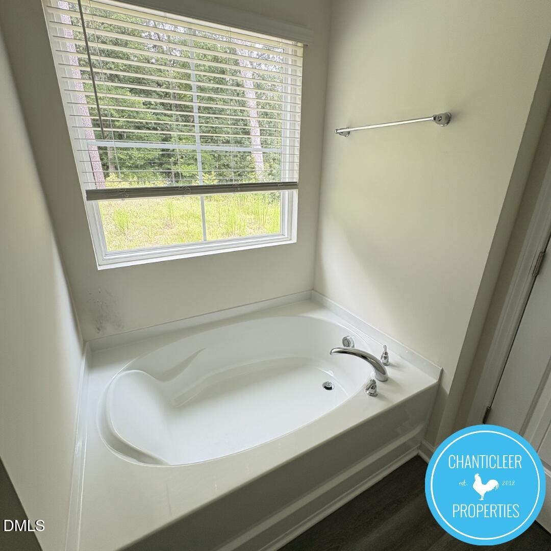 3318 Slippery Elm Drive Raleigh, NC 27610 - Photo 17 of 25 a bathroom with a bathtub and a window