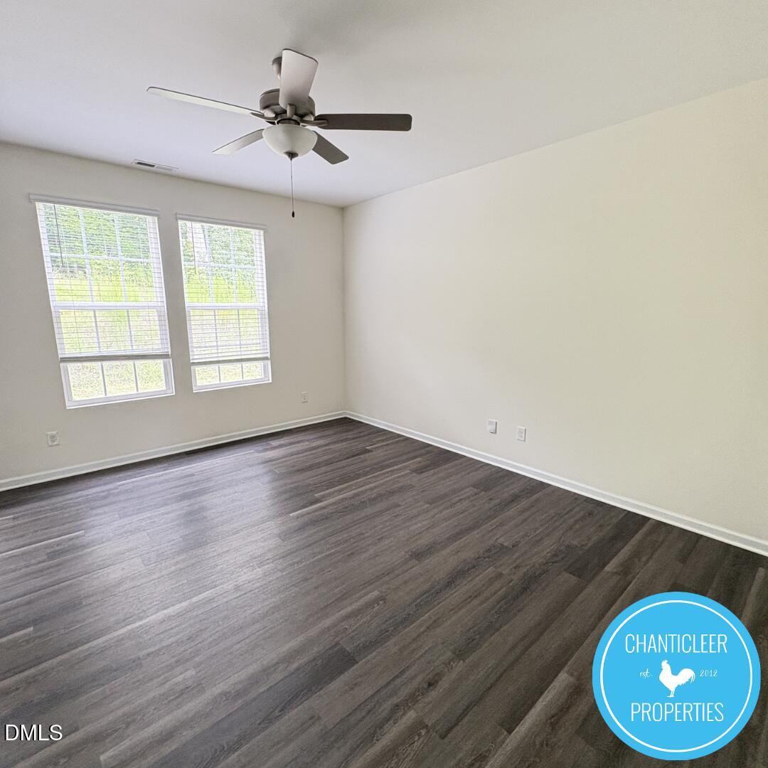 3318 Slippery Elm Drive Raleigh, NC 27610 - Photo 2 of 25 an empty room with wooden floor and windows
