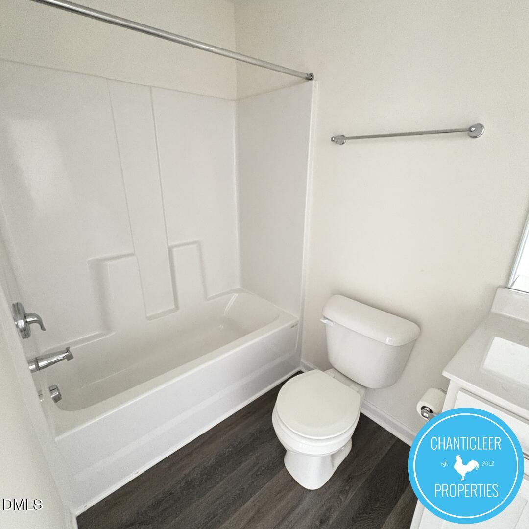 3318 Slippery Elm Drive Raleigh, NC 27610 - Photo 23 of 25 a white toilet sitting next to a bath tub