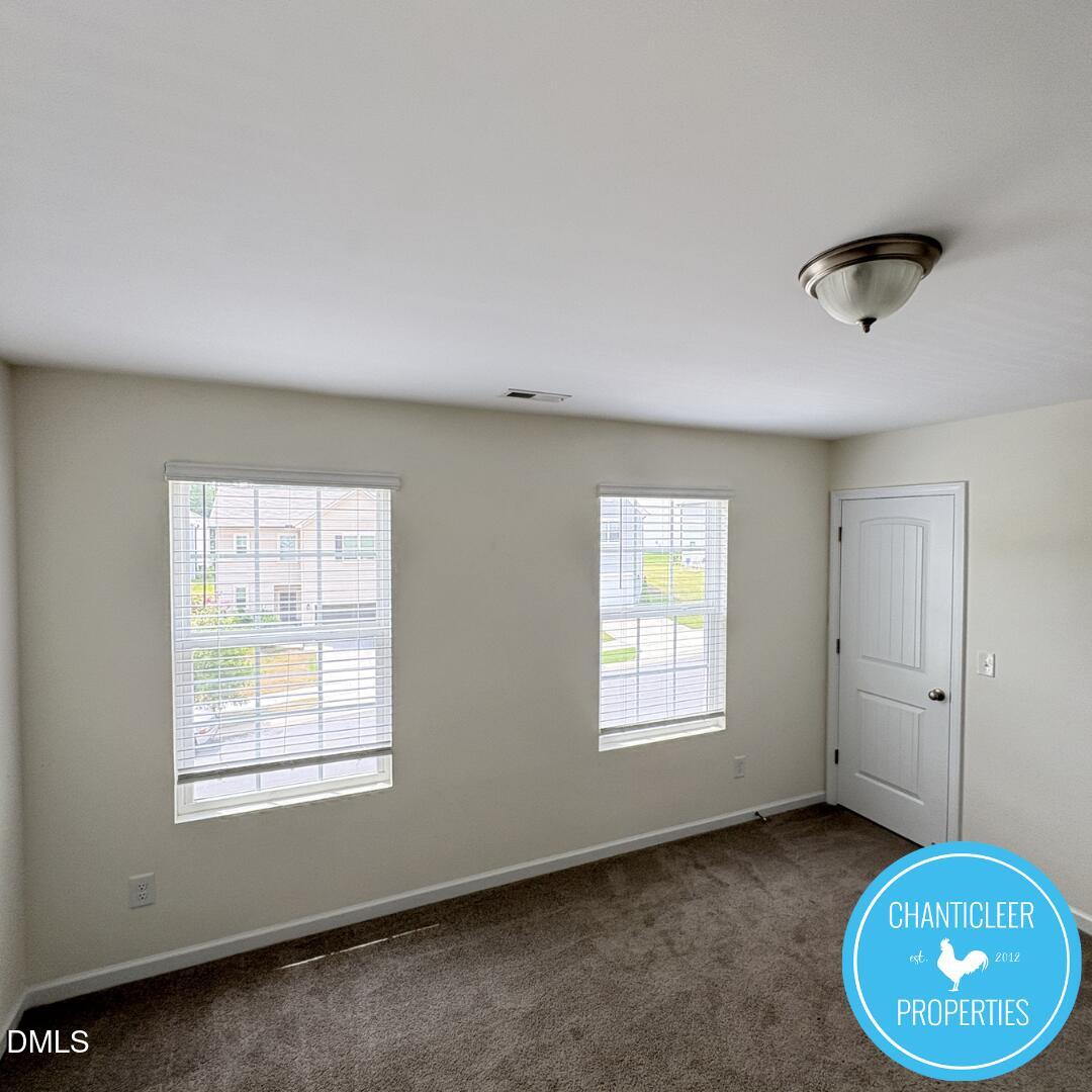 3318 Slippery Elm Drive Raleigh, NC 27610 - Photo 24 of 25 a view of an empty room with a window and a kitchen