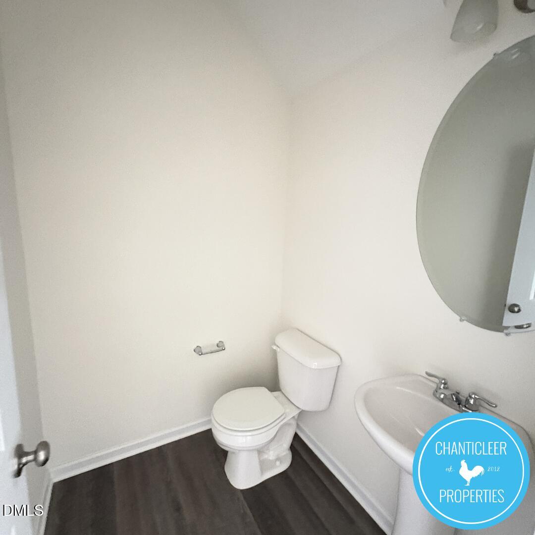 3318 Slippery Elm Drive Raleigh, NC 27610 - Photo 4 of 25 a white toilet sitting next to a bathroom sink