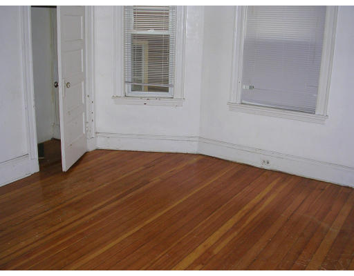 81 Montebello Road Boston, MA 02130 - Photo 4 of 9 a view of empty room with wooden floor and fan