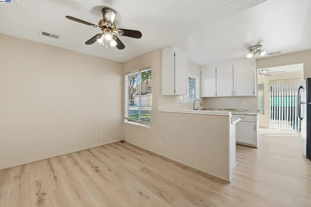 a view of kitchen with sink and wooden floor