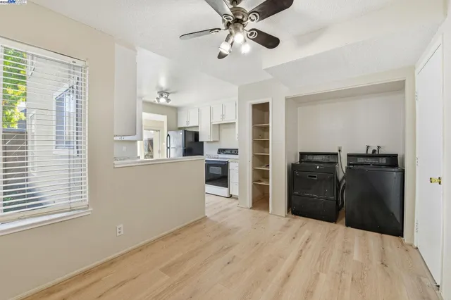 a kitchen with granite countertop a refrigerator and a sink