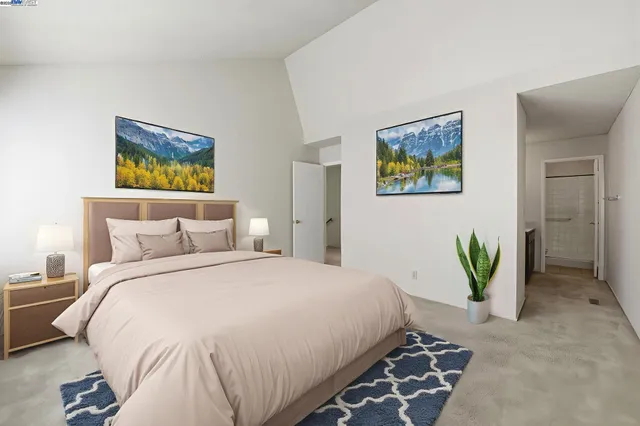 a bedroom with a bed and a painting on the wall