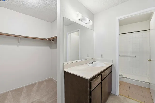 a bathroom with a sink a mirror and a shower
