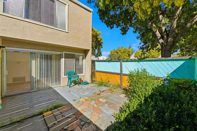 a view of a house with a yard and a fence