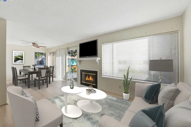 a living room with furniture a fireplace and a flat screen tv