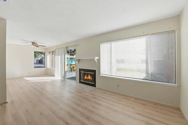 a view of a livingroom with a fireplace and window