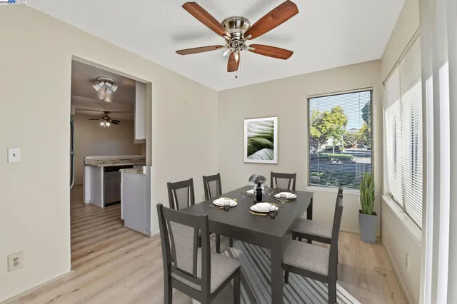 a dining room with furniture window and wooden floor