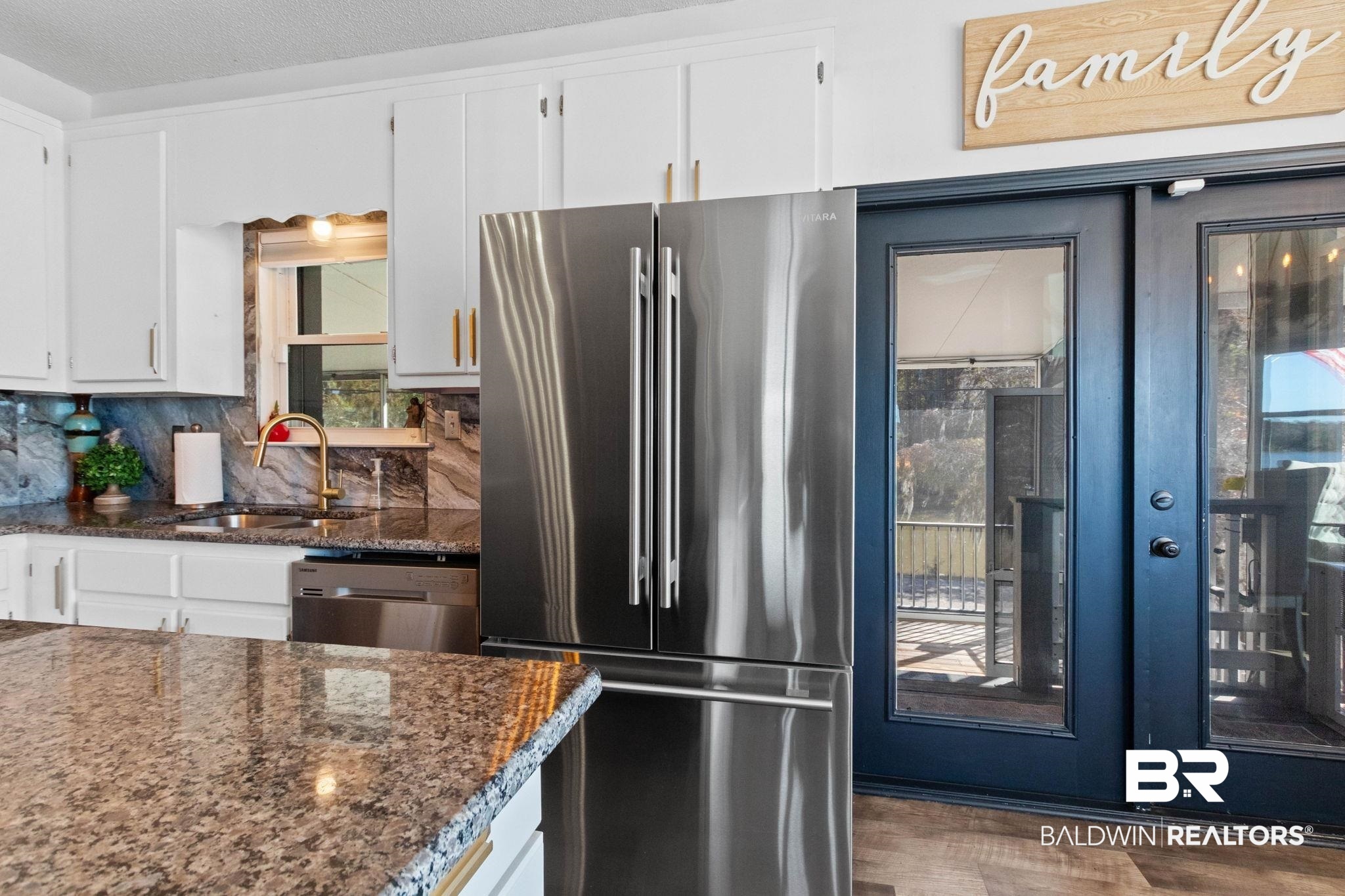 41997 Bayou Road Bay Minette, AL 36507 - Photo 5 of 68 Kitchen featuring appliances with stainless steel finishes, dark stone counters, white cabinetry, tasteful backsplash, and dark wood-type flooring