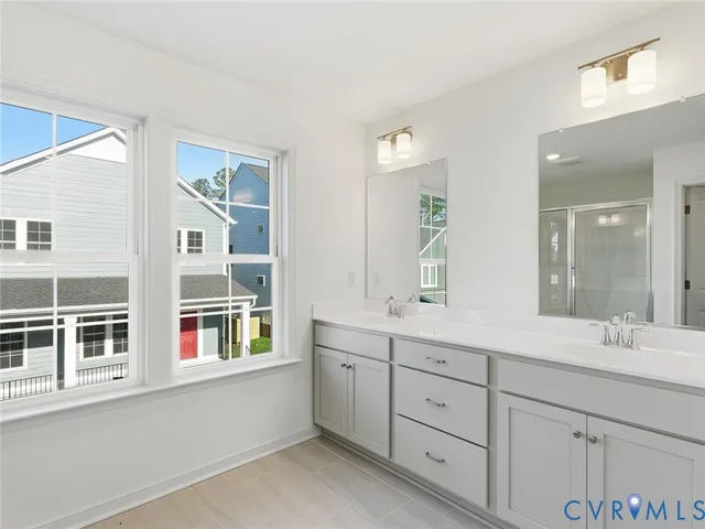 a bathroom with a double vanity sink and mirror