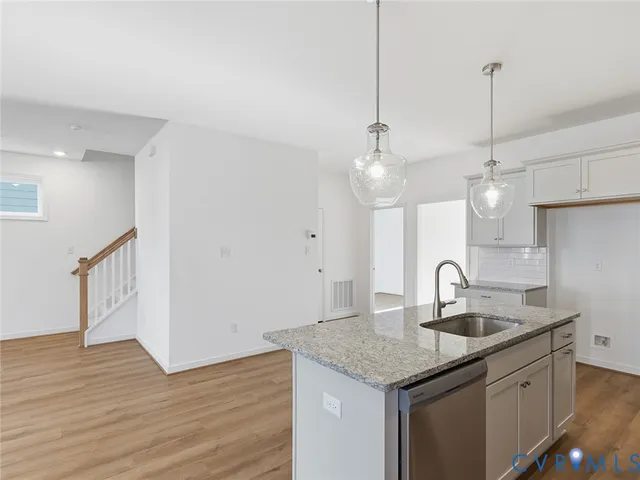 a kitchen with a sink and chandelier