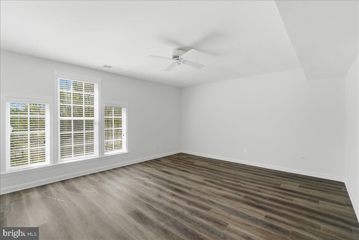 1304 F Garden Wall Circle Reston, VA 20194 - Photo 11 of 23 an empty room with wooden floor and windows